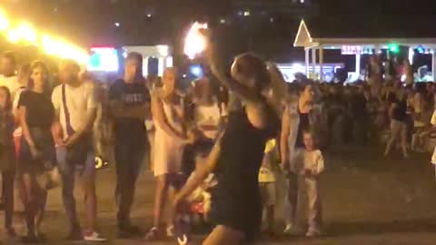 girl performs a fire show