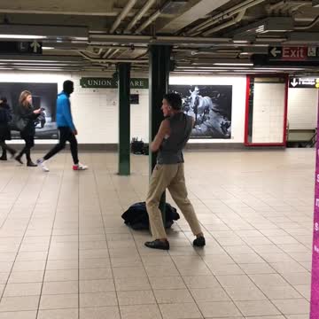 Sleeveless vest does karate in subway terminal