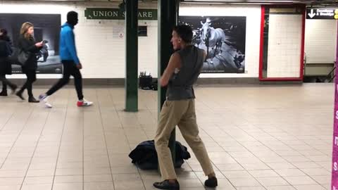 Sleeveless vest does karate in subway terminal