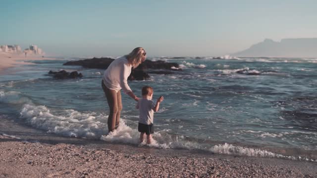 Mother And Son Playing On The Seashore