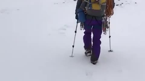 A man is walking in snow covered mountain