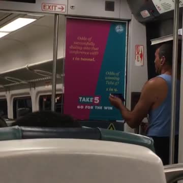 Man in blue balancing book on head