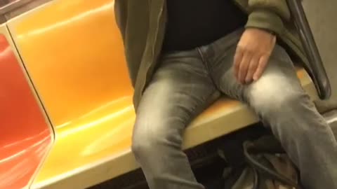 Man green bomber jacket shaving on subway