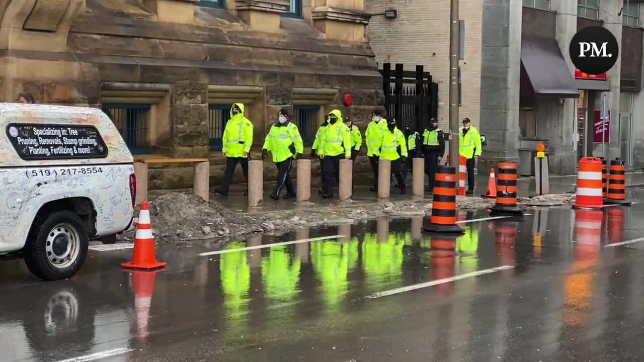 The day after protestors were issued notices telling them to leave, numbers of police are walking through downtown Ottawa