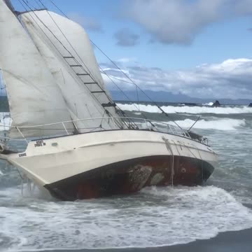 Sailboat stuck on shore beach water