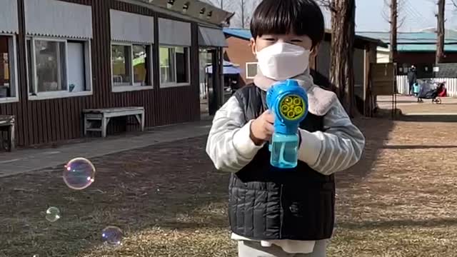 A baby makes bubbles.