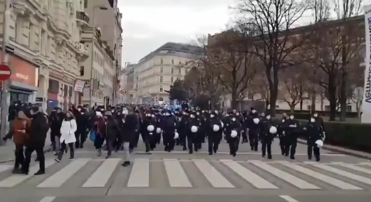 More of Vienna police helmets off marching with protesters.