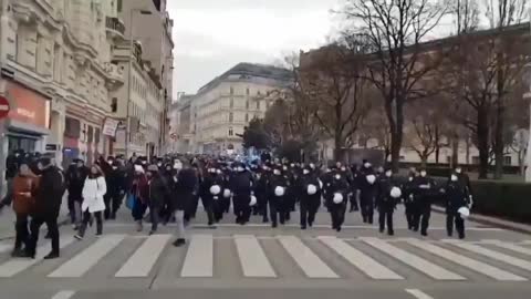 More of Vienna police helmets off marching with protesters.