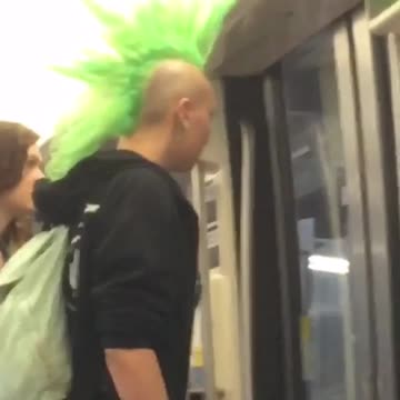 Guy with big green mohawk getting off subway train