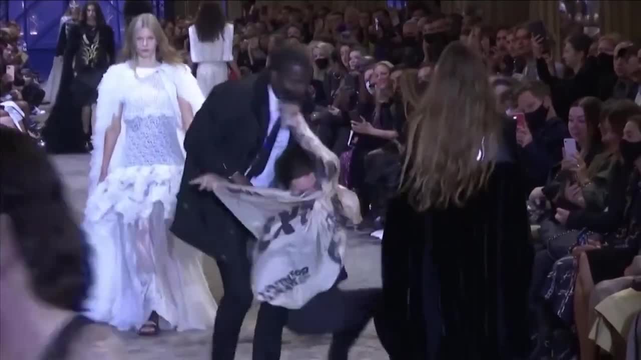 Extinction Rebellion protestor tackled by security at fashion show