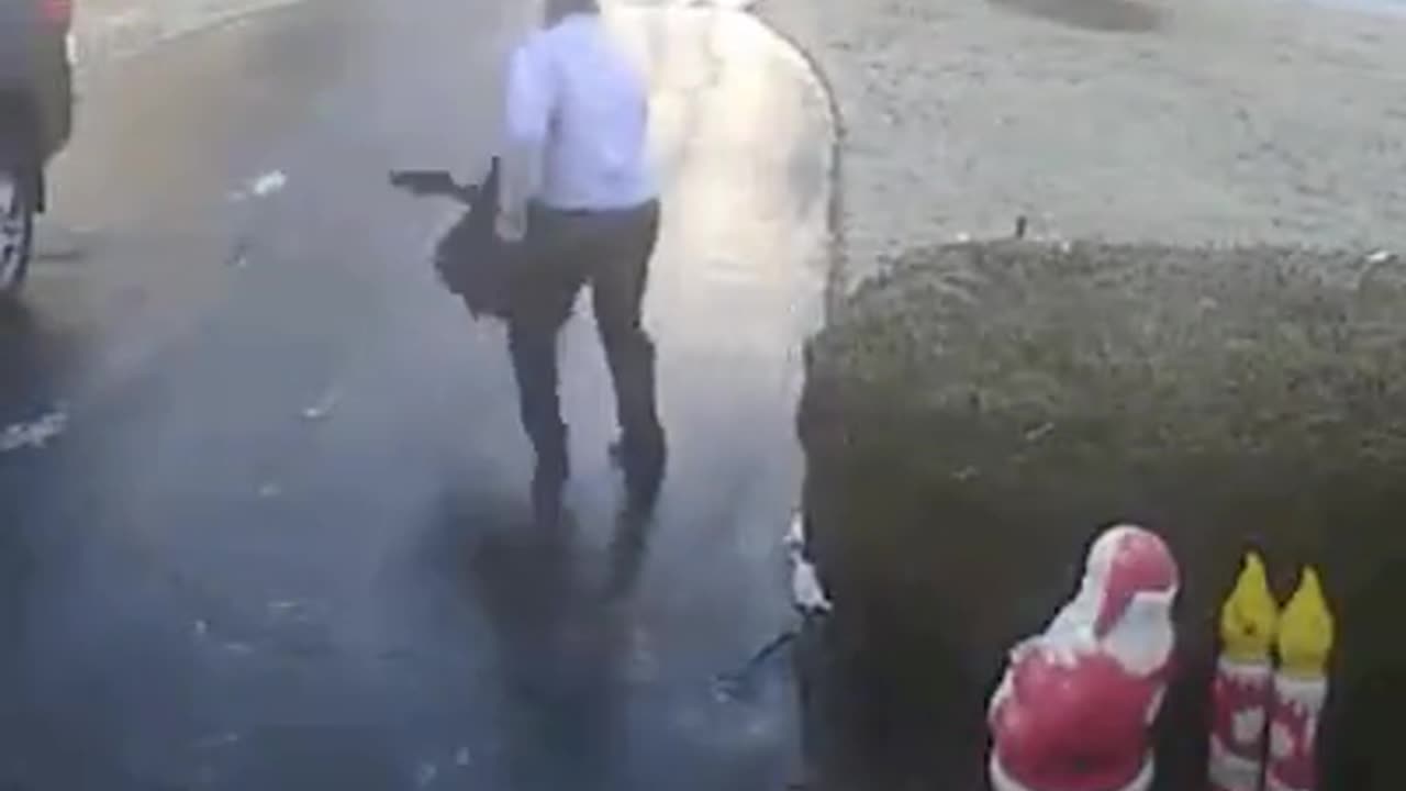 guy walks onto ice covered driveway and slides out of control