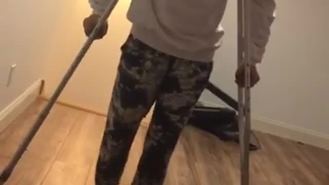 Girl crutches leg kick falls on butt