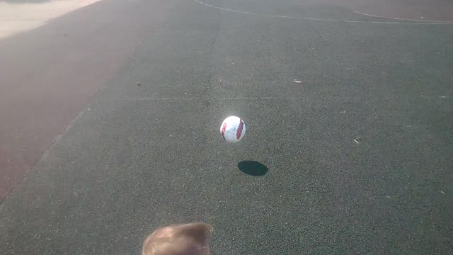 The little girl playing with ball