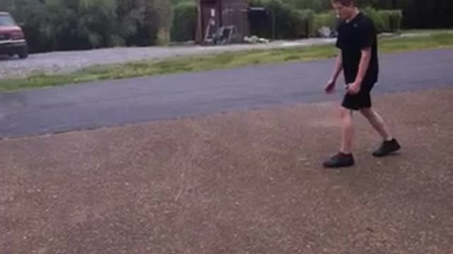 Black shirt kid tries to frontflip from pavement to grass