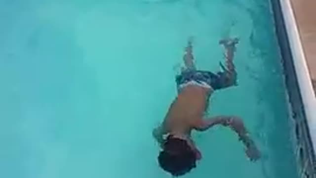 5 Year old doing back flips in the pool.