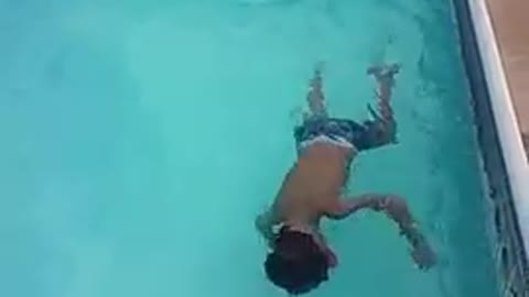 5 Year old doing back flips in the pool.