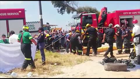 Rescuers try to find construction workers who fell into a manhole in Rocklands Mitchells Plain