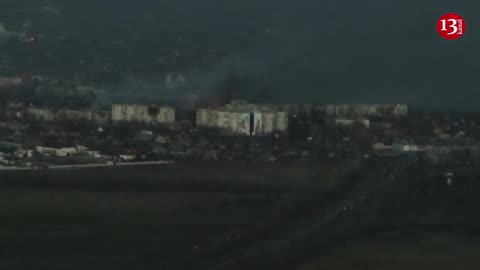 Military drone shows scale of destruction in Bakhmut, houses on fire