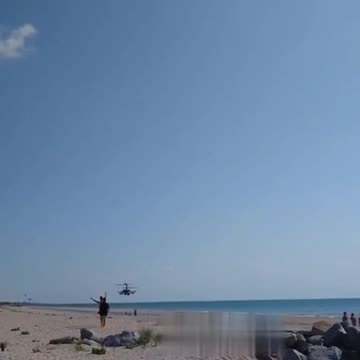 Mi-28N and Kamov Ka-52 combat helicopters fly over the beaches of the Azov Sea.