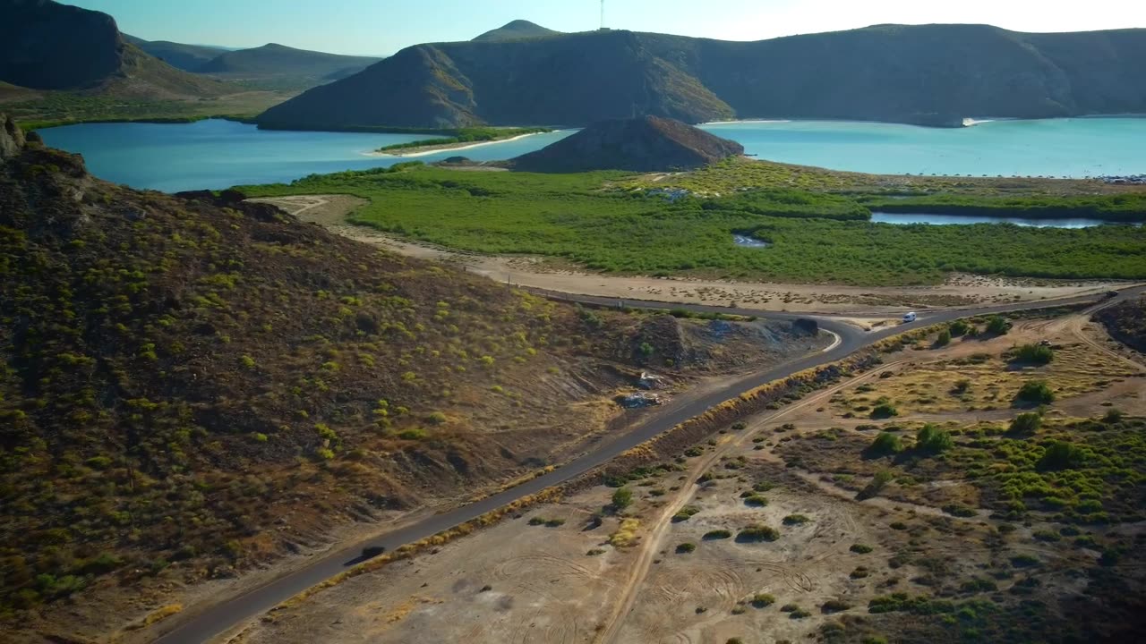 Aerial panorama of a landscape with mountains and a lake