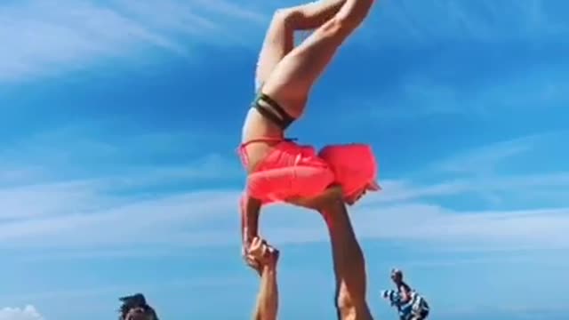 Acrobatic Duo Performs Tricks on beach