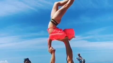 Acrobatic Duo Performs Tricks on beach