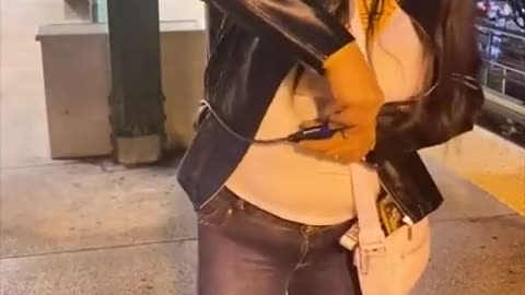 Woman straps herself to pole to prevent being shoved onto subway tracks