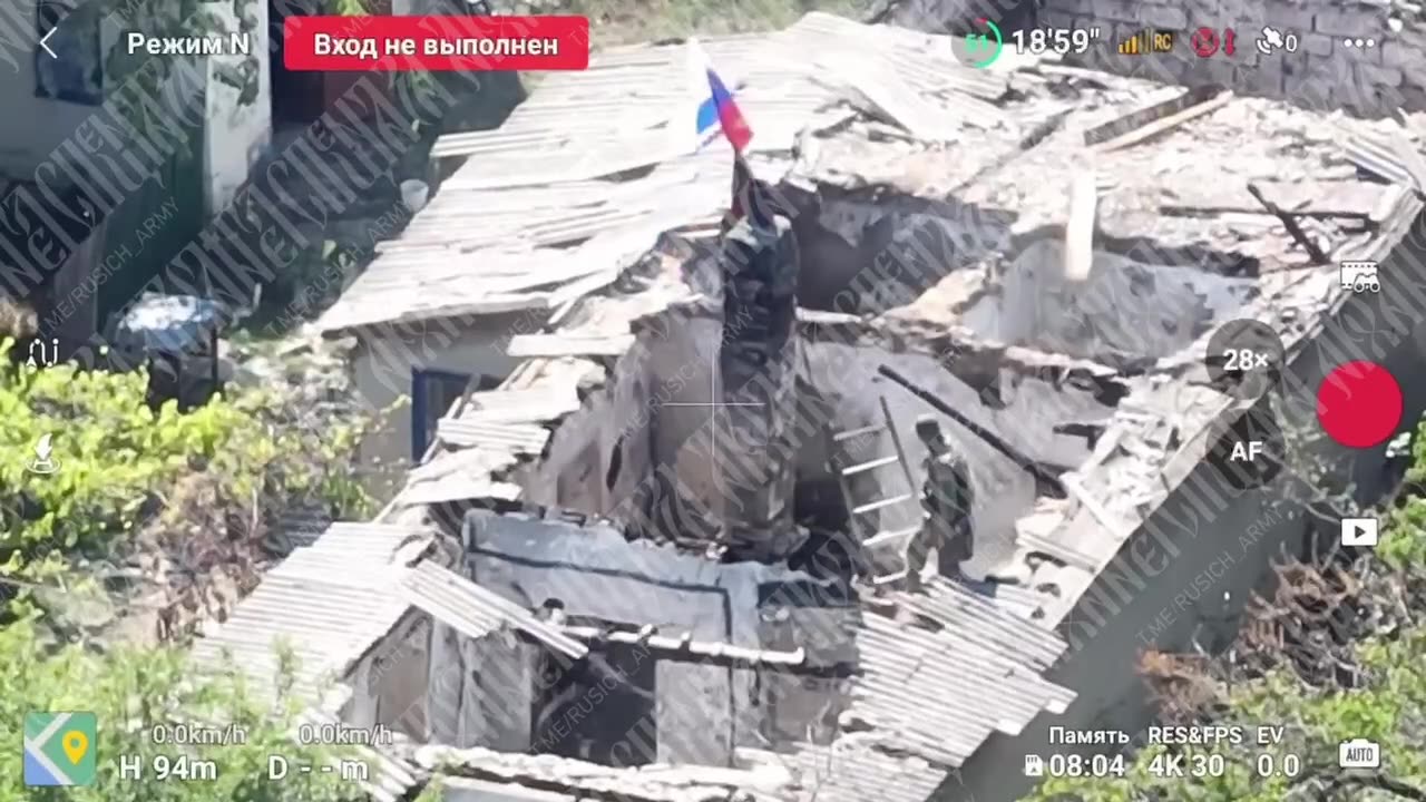 Russian storm troopers in the village of Zavetnoye with the Russian flag.