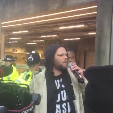 : Protesters gather outside Balenciaga store in London.