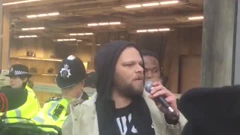 : Protesters gather outside Balenciaga store in London.