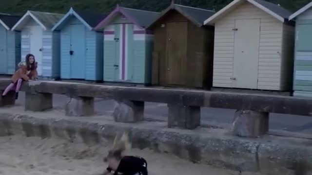 Little Girl Faceplants in Sand After Attempting to Perform Front Flip Off Rail