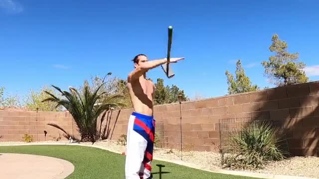 Man Performs Tricks With Long Hammer