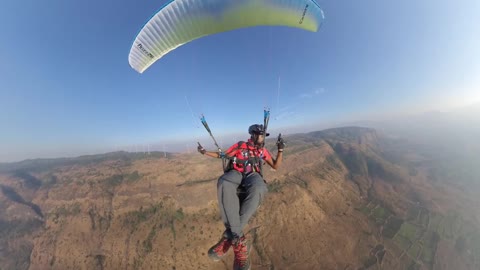 Guy Paraglides Over Mountains And Fields In India