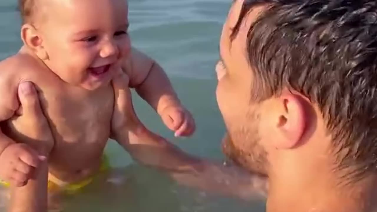 beach going baby belly laughing