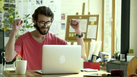 Man celebrating in front of the computer