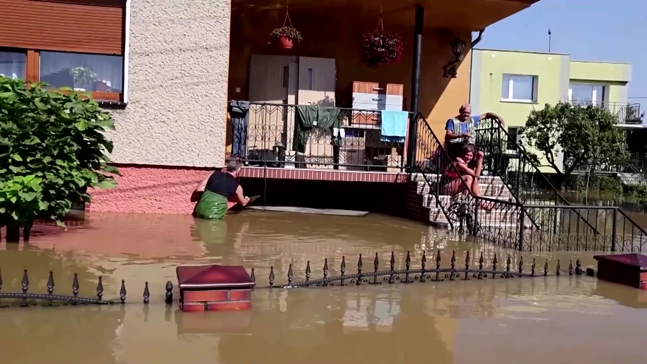 Evacuations by digger and boat as floodwaters invade Polish town