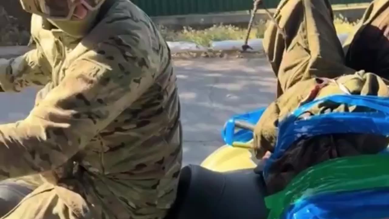 Ukrainians Moving Russian Soldier Away from Front Lines
