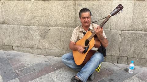 Madrid/Spain - Street Musician with a Guitar