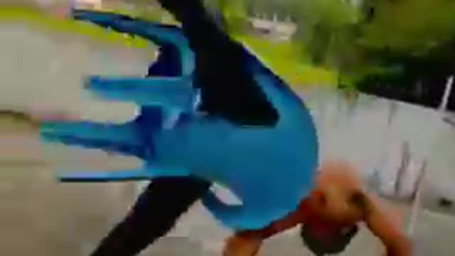 Man Performs Tricks With His Legs Stuck in Plastic Chair