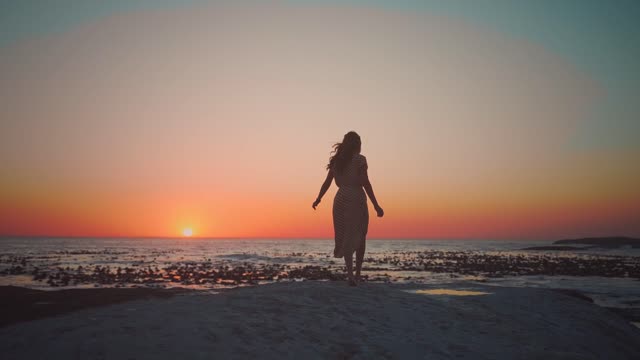 Lovers walking on the beach in the sunset