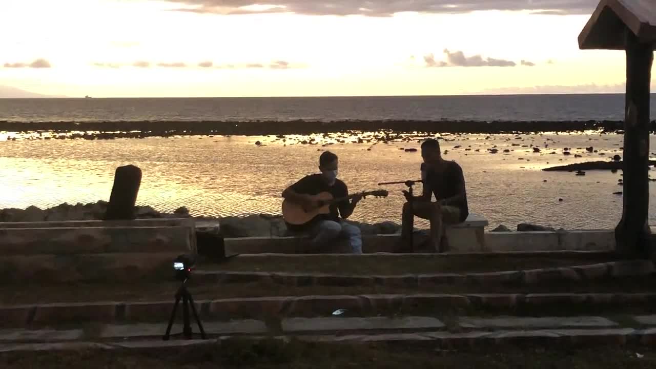 Playing guitar by the sea