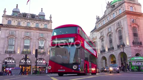 Early evening doubledecker bus and London taxi traffic moves