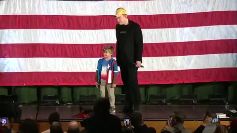 Elon Musk signs a young boy’s Phillies hat at a Town Hall in Folsom, PA