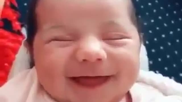 A very beautiful newborn baby smiled a very sweet smile