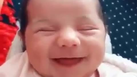 A very beautiful newborn baby smiled a very sweet smile