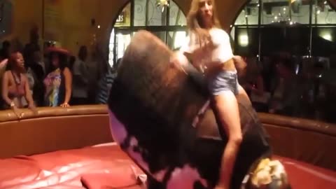 A girl on a cow. That's something.