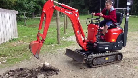 Jims Excavator #27 - Daniel digging up surface rocks in the pasture.