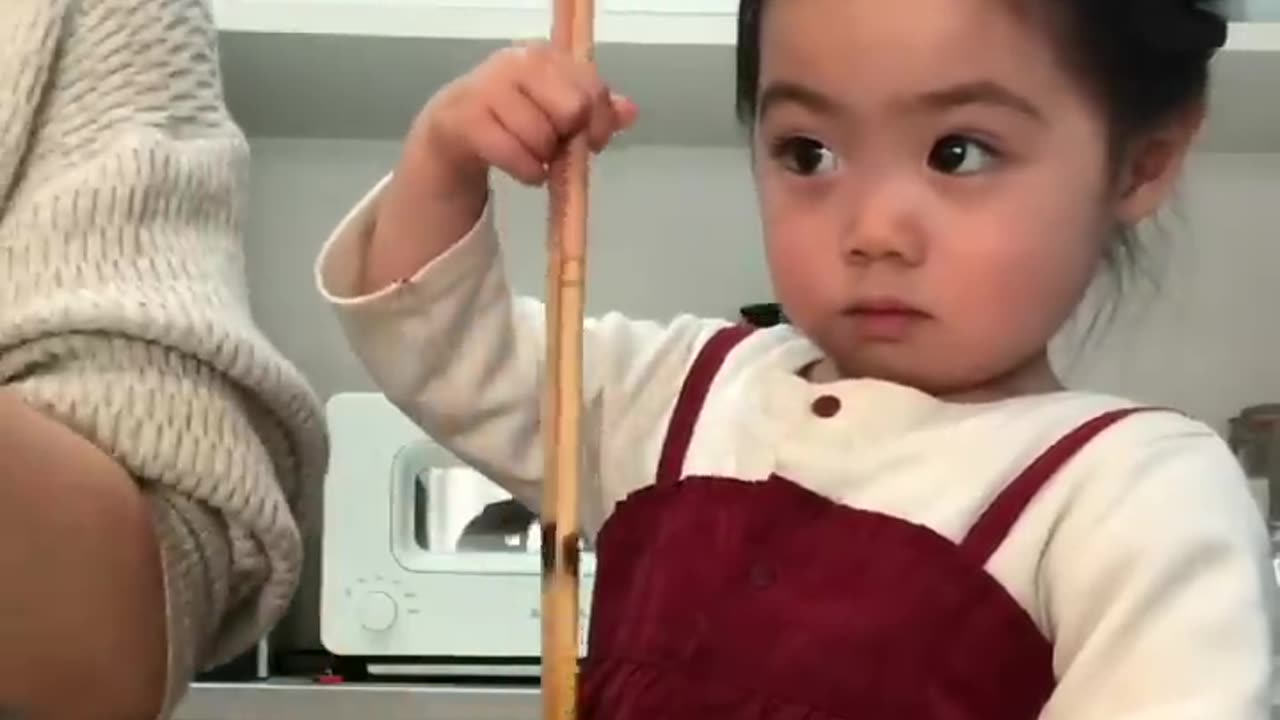 Stir the air -cute baby helping her mom