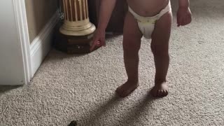 Baby chases frog and catches him