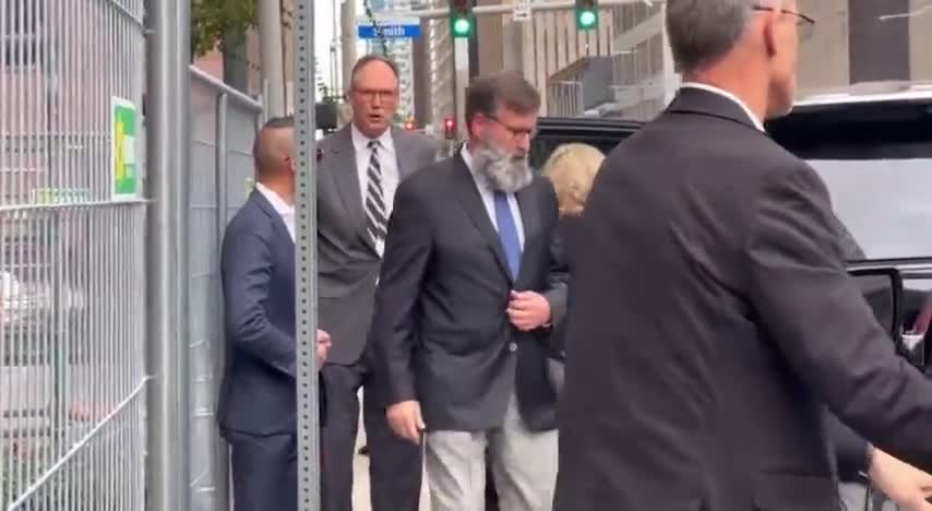 Katherine Engelbrecht and Gregg Phillips leave federal court in Houston